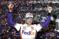 FILE - In this Monday, Feb. 17, 2020 file photo,Denny Hamlin celebrates in Victory Lane after winning the NASCAR Daytona 500 auto race at Daytona International Speedway in Daytona Beach, Fla. NASCAR eased off the brake in the real sports world brought to a sudden halt by the coronavirus and introduced the country to iRacing with some of the sports biggest stars. Hamlin, the three-time Daytona 500 winner, beat Dale Earnhardt Jr. off the final corner Sunday, March 22, 2020 at virtual Homestead-Miami Speedway to win the bizarre spectacle. (AP Photo/John Raoux, File)