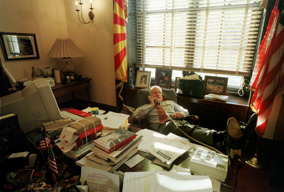 <p>Sen. John McCain kicks back in his chair and places a phone call while working in his Capitol Hill office in Washington during the Senate debate on the McCain-Finegold campaign finance reform bill in 2001. McCain tackled the system of campaign financing with like-minded Democrats, an issue which split him from Republican leaders. (Photo: Stephan Savoia/AP) </p>