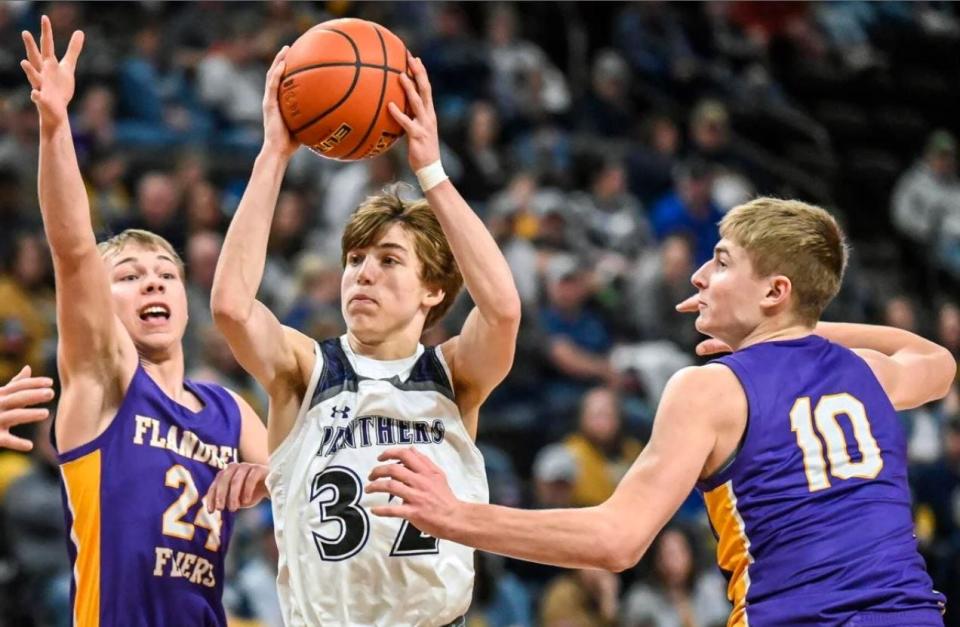 Dakota Valley's Randy Rosenquist splits the defense of Flandreau's Alex Anderson (24) and Chase LeBrun (10) during a game in the semifinals of the Class A state tournament on Friday at Summit Arena.