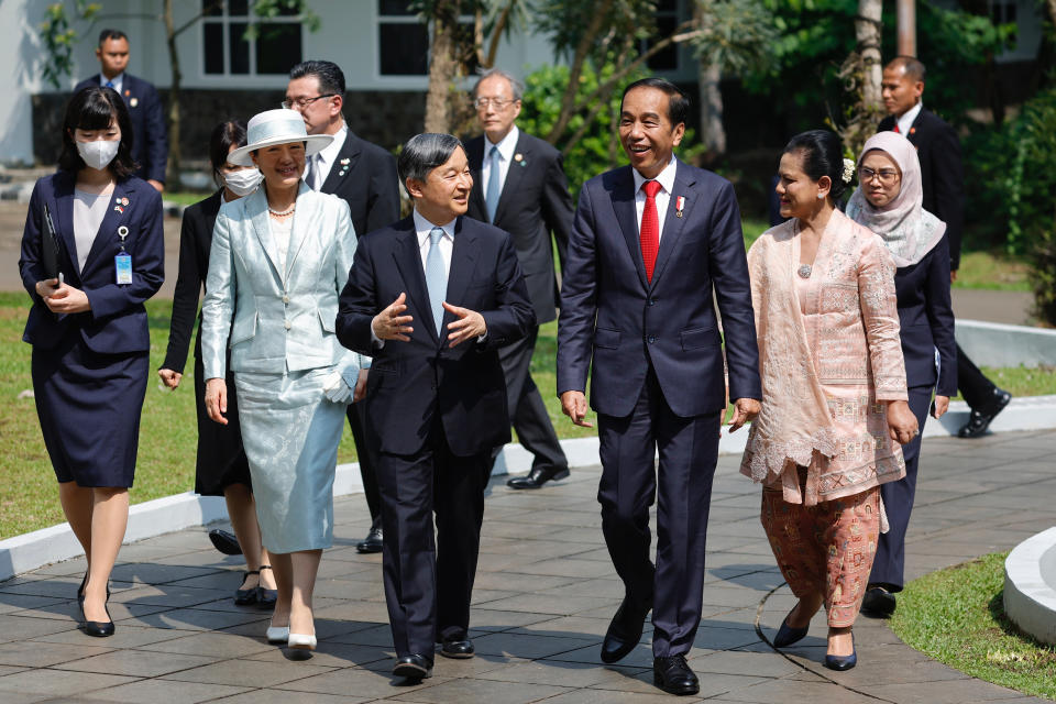 Japan's Emperor Naruhito, center, talks with Indonesian President Joko Widodo, center right, as they walk with Empress Masako, third left, and Widodo's Wife Iriana, second right, during their visit at Bogor Botanical Gardens in Bogor, Indonesia, Monday, June 19, 2023. (Willy Kurniawan/Pool Photo via AP)