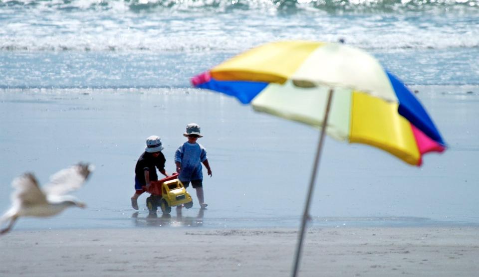 In this file photo, children push a toy truck along the shoreline of Jenness State Beach in Rye, NH