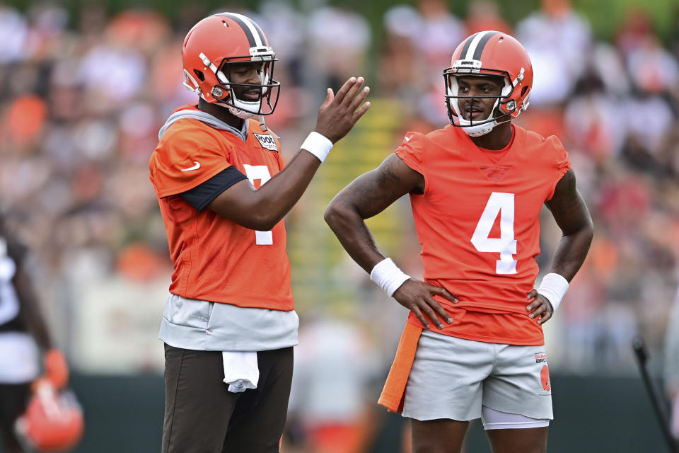 Cleveland Browns quarterback Deshaun Watson, right, and quarterback Jacoby Brissett talk during an NFL football practice in Berea, Ohio, Sunday, Aug. 14, 2022. (AP Photo/David Dermer)