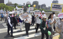 <p>Demonstrators rally near the Hiroshima Peace Memorial Park in Hiroshima, western Japan, Friday, May 27, 2016. (Photo: Foster Klug/AP) </p>