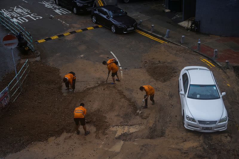 FILE PHOTO: Workers remove debris in the aftermath of flooding and heavy rain in Hong Kong
