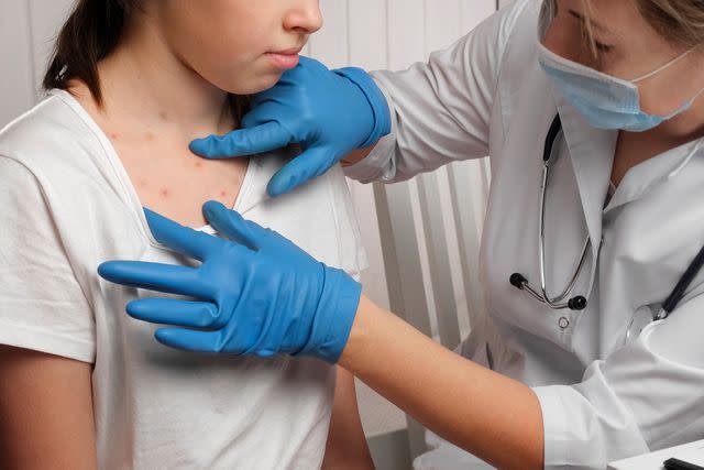 <p>Getty</p> Stock photo of doctor checking out a girl who's sick.