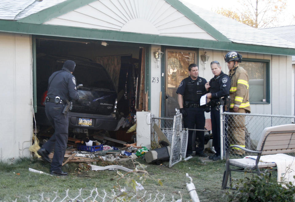 A vehicle drove completely into a home in Anchorage, Alaska, on Tuesday, Oct. 11, 2011, barely missing the homeowner, who was sitting in a chair that the SUV missed by inches. The driver was taken to the hospital with minor injuries; the homeowner was skaken up but unhurt. (AP Photo/Mark Thiessen)