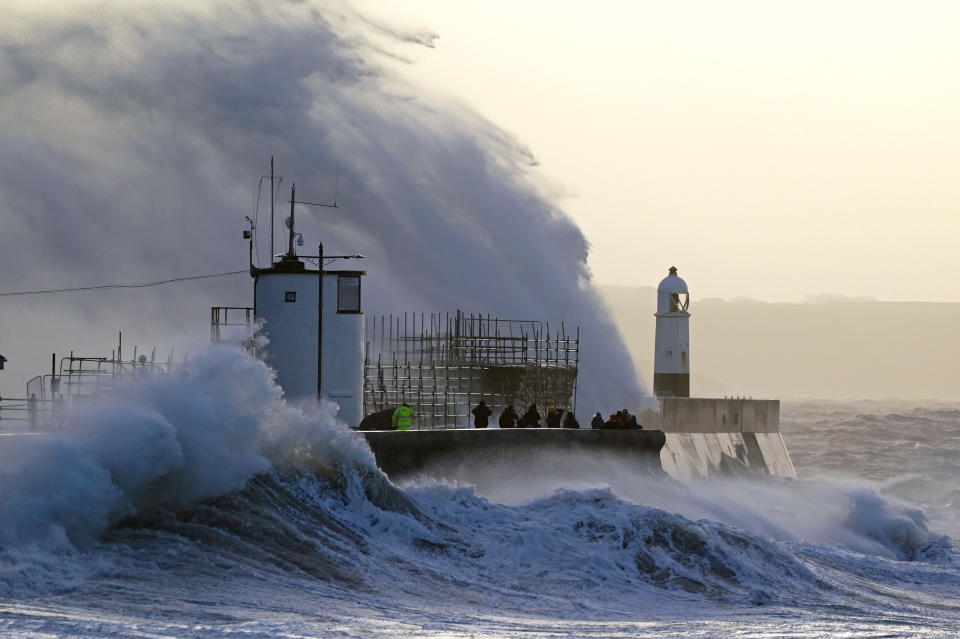 Waves crash against the sea wall and Porthcawl Lighthouse in Porthcawl, Bridgend, Wales, as Storm Eunice hits the south coast, with attractions closing, travel disruption and a major incident declared in some areas, meaning people are warned to stay indoors. A rare red weather warning - the highest alert, meaning a high impact is very likely - has been issued by the Met Office due to the combination of high tides, strong winds and storm surge. Picture date: Friday February 18, 2022. (Photo by Jacob King/PA Images via Getty Images)