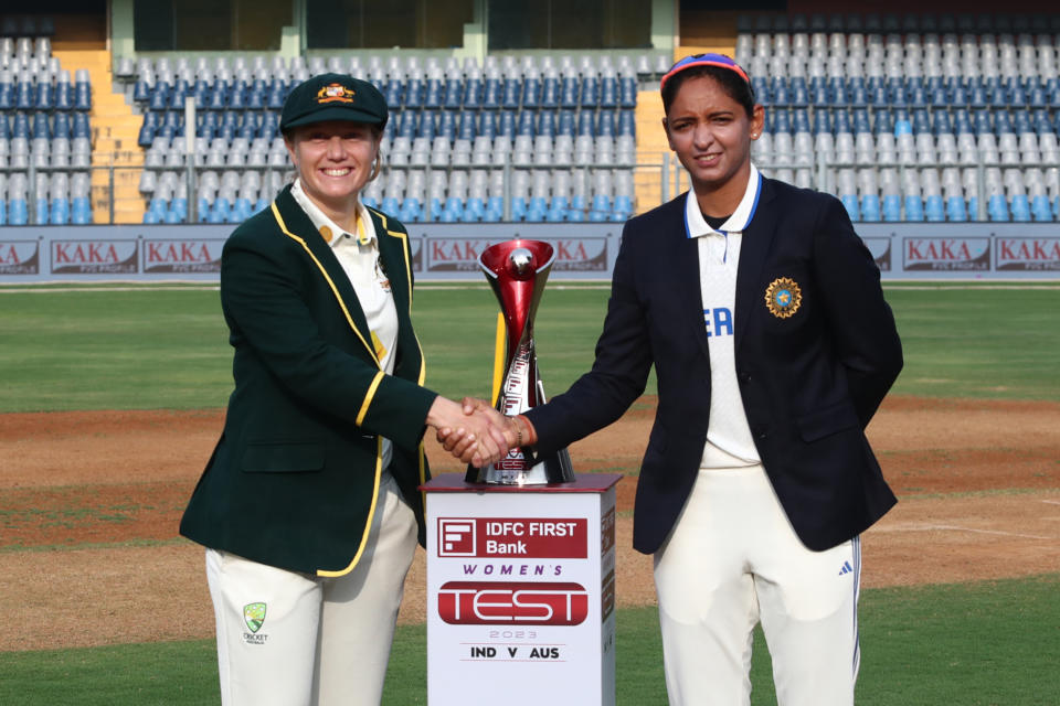 MUMBAI, INDIA - DECEMBER 21: Captains Alyssa Healy of Australia and Harmanpreet Kaur of India pose for photos as they participate in the coin toss during day one of the Women's Test Match between India and Australia at Wankhede Stadium on December 21, 2023 in Mumbai, India. (Photo by Pankaj Nangia/Getty Images)