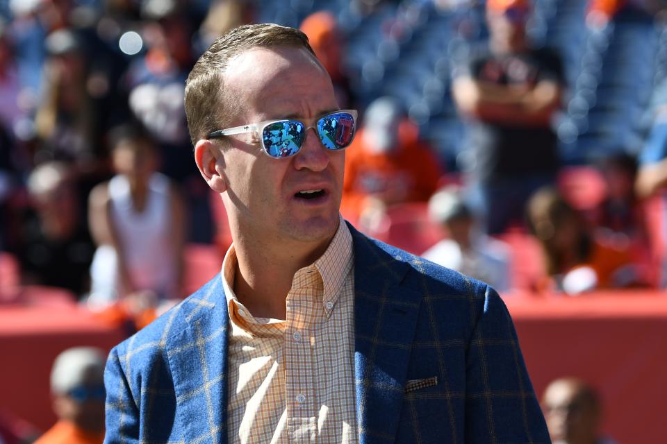 Peyton Manning watches a Denver Broncos game in 2019.