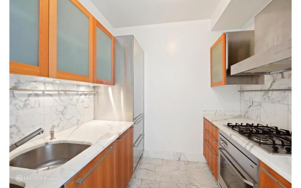 <p>The kitchen features top-of-the-line stainless steel appliances.</p>