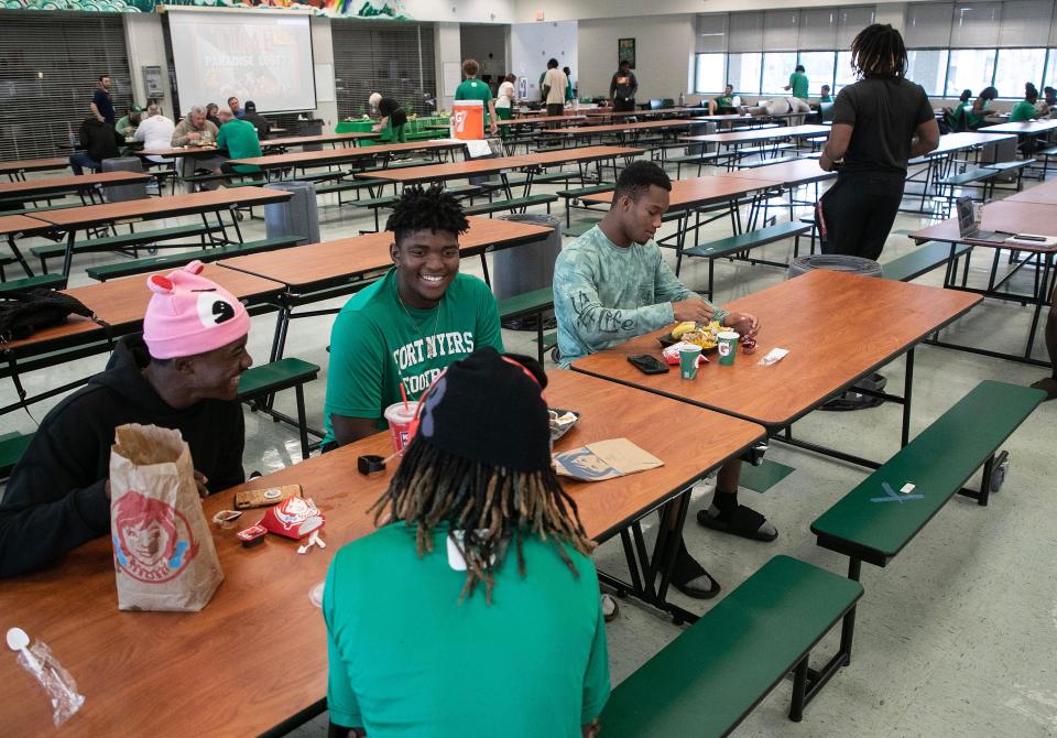 Fort Myers High School football players joke around as they eat their pre-game meal on Thursday, Oct. 19, 2023, at Fort Myers High School.