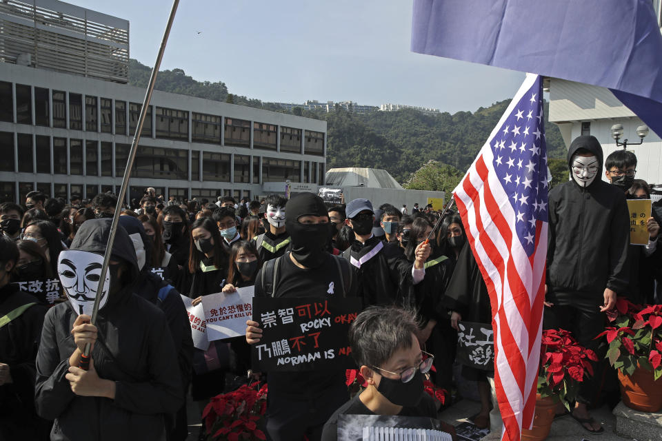 University students wearing Guy Fawkes masks protest against the government before their graduation ceremony at the Chinese University of Hong Kong, in Hong Kong, Thursday, Nov. 7, 2019. (AP Photo/Kin Cheung)