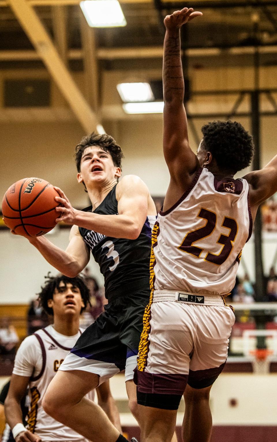 South's Jack Clark (3) shoots over North's Christopher Vaughns Jr. (23) during the Bloomington North versus Bloomington South boys basketball game at Bloomington High School North on Friday, Jan. 5, 2024. North won the game 56-53.