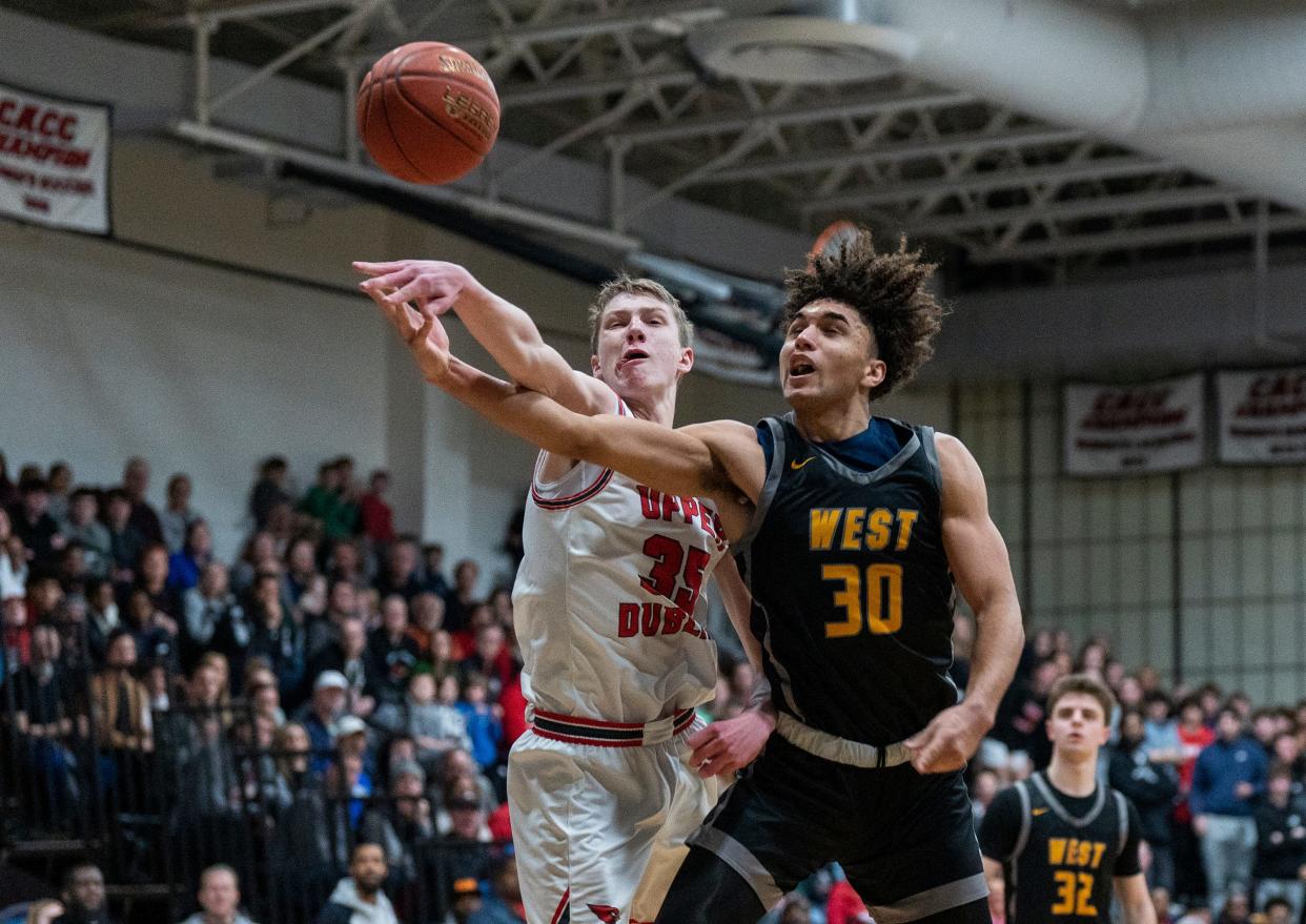 Central Bucks West's Julian Phillips (30) and Upper Dublin's Brady Fogle (35) pursue the ball during the Suburban One League Tournament championship game.