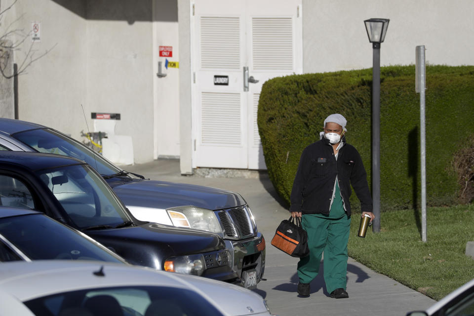 A health care worker leaves Cedar Mountain Post Acute nursing facility in Yucaipa, Calif., Wednesday, April 1, 2020. The Southern California nursing home has been hit hard by the coronavirus, with more than 50 residents infected, a troubling development amid cautious optimism that cases in the state may peak more slowly than expected. (AP Photo/Chris Carlson)