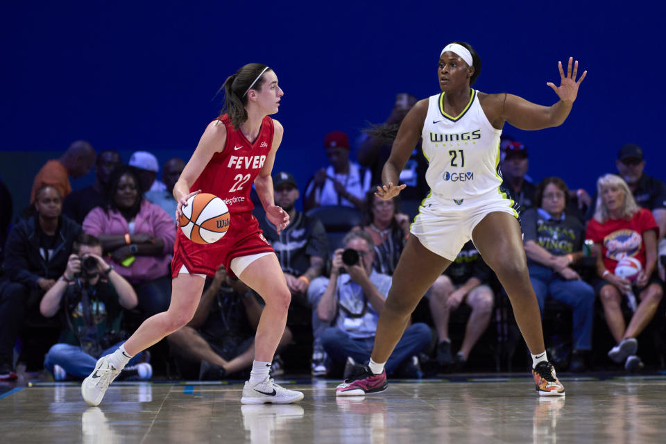 ARLINGTON, TEXAS - JULY 17: Caitlin Clark #22 of the Indiana Fever drives to the basket against Kalani Brown #21 of the Dallas Wings at the College Park Center on July 17, 2024 in Arlington, Texas. NOTE TO USER: User expressly acknowledges and agrees that by downloading and/or using this photo, User agrees to the terms and conditions of the Getty Images License Agreement. (Photo by Cooper Neill/Getty Images)