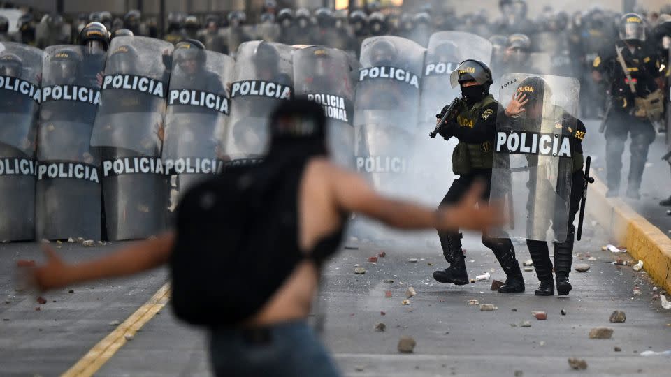 Demonstrators clash with riot police in January during a protest against the government of Dina Boluarte. - Ernesto Benavides/AFP/Getty Images/FILE