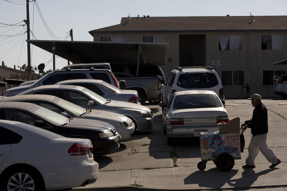 In this Thursday, Sept. 6, 2018, photo, cars are double-parked in the parking lot of an apartment complex in Salinas, Calif. Salinas is an affordable location compared to Silicon Valley, where median home prices are about $1 million, but with a less-wealthy population and a median home price that has ballooned to about $550,000, it's one of the least affordable places in America. (AP Photo/Jae C. Hong)