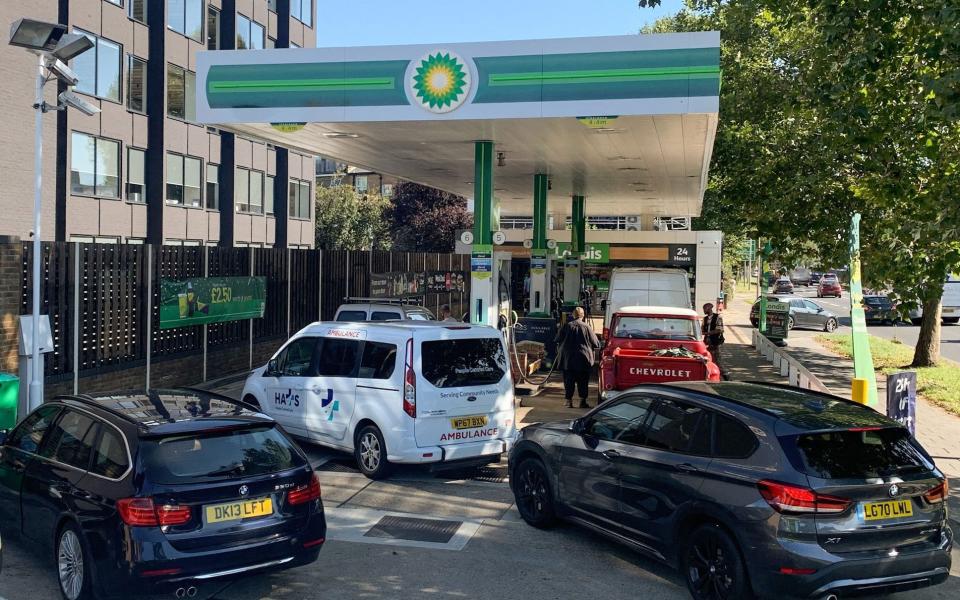 Cars queue at a BP petrol station in west London on Friday