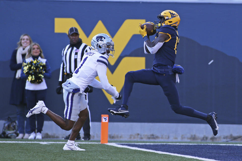 West Virginia wide receiver Sam James catches a touchdown pass while defended by Kansas State safety Josh Hayes during the first half of an NCAA college football game in Morgantown, W.Va., Saturday, Nov. 19, 2022. (AP Photo/Kathleen Batten)