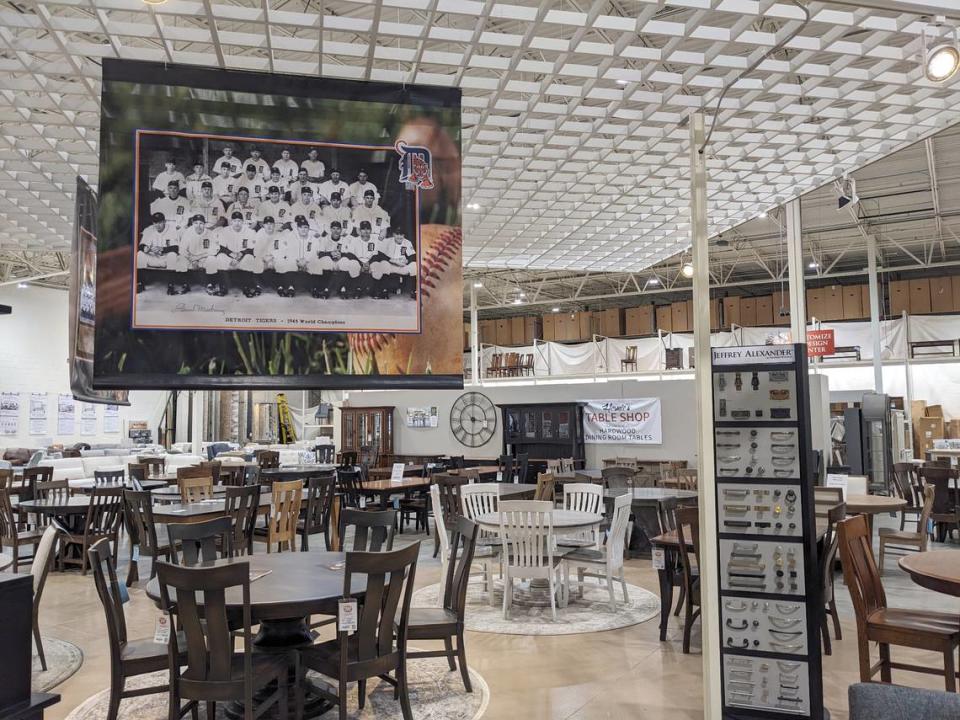 New signs featuring historic photos hang at Mueller Furniture & Mattress Warehouse Showroom, including some that feature Les Mueller, who pitched for the Detroit Tigers.