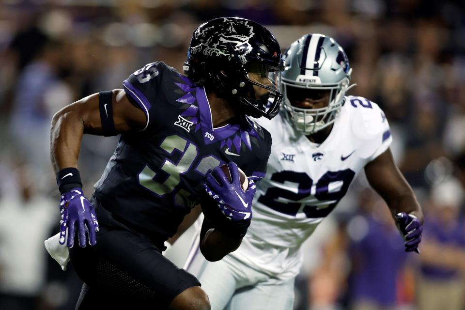 Kansas State defensive end Khalid Duke (29) chases down TCU's Kendre Miller (33) during their Oct. 22, 2022 game in Fort Worth, Texas.