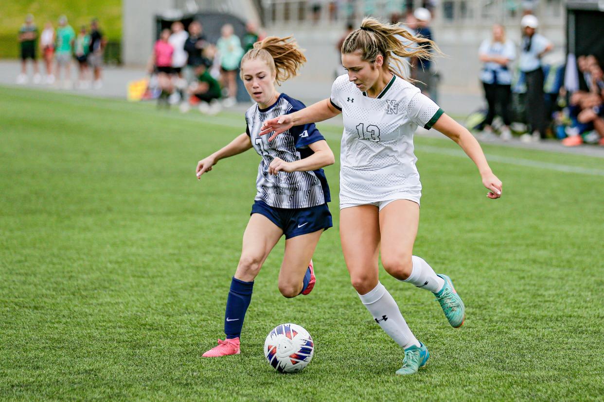 Edmond North’s Olivia Waters (7) and Norman North’s Presley Boyd (13) fight for the ball during the Class 6A girls state championship soccer game between Edmond North and Norman North at Taft Stadium in Oklahoma City, on Saturday, May 11, 2024.