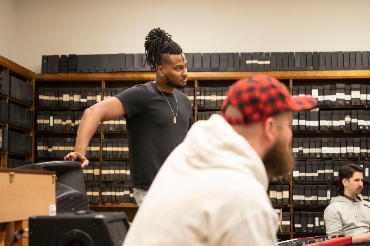 Brandon Fitzpatrick chats with bandmates during rehearsal at First Congregational Church in Battle Creek on Tuesday, March 28, 2023.