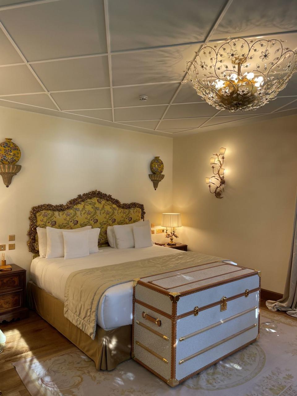 a bed with a chandelier above it