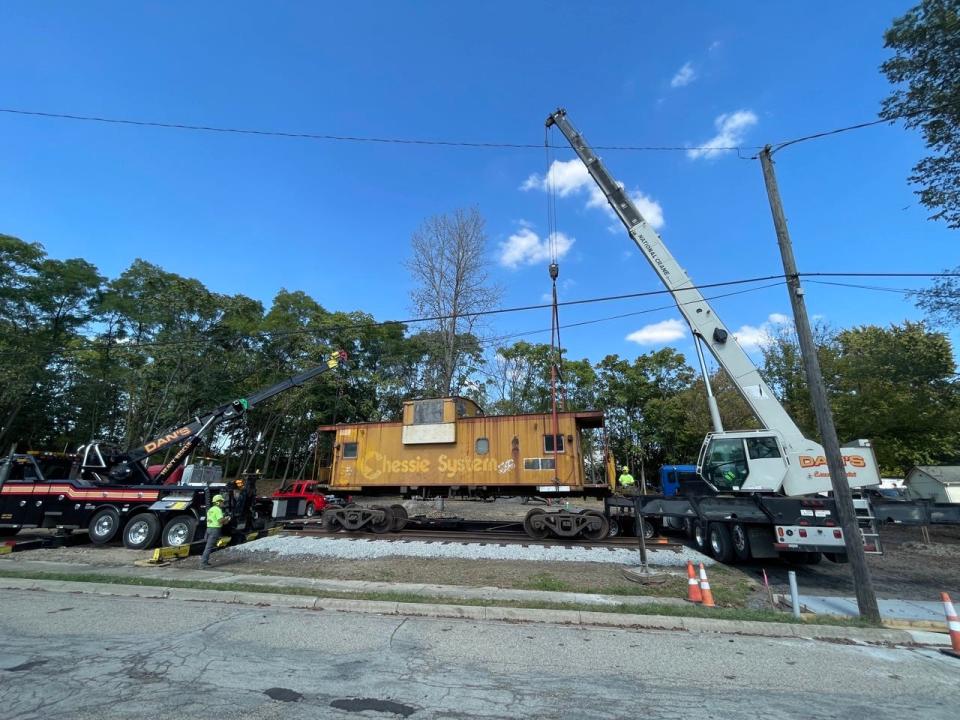 The Chessie System caboose lifted by a crane