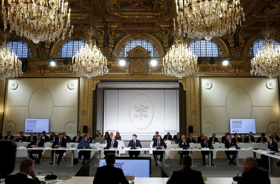 French President Emmanuel Macron, center, delivers a speech at the Elysee Palace in Paris, Monday, Feb. 26, 2024. More than 20 European heads of state and government and other Western officials are gathering in a show of unity for Ukraine, signaling to Russia that their support for Kyiv isn't wavering as the full-scale invasion grinds into a third year. (Gonzalo Fuentes/Pool via AP)