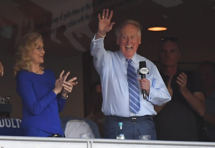 Vin Scully acknowledges the crowd from a box before Game 5 of the National League baseball championship series between the Chicago Cubs and the Los Angeles Dodgers Thursday, Oct. 20, 2016, in Los Angeles. (AP Photo/Mark J. Terrill)