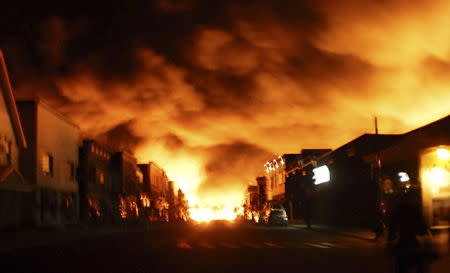 Fire from an oil train explosion is seen in Lac Megantic, Quebec in this July 6, 2013 file photograph. REUTERS/Stringer/Files