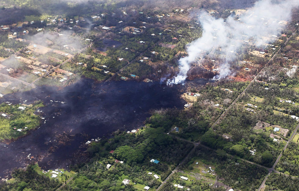 Smoke and volcanic gases rise as lava cools in the Leilani Estates neighborhood, in the aftermath of eruptions and lava flows from the Kilauea volcano on Hawaii's Big Island, on May 11, 2018.