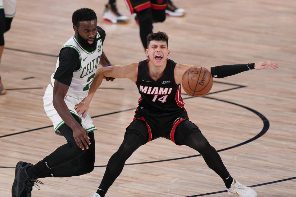 Boston Celtics' Jaylen Brown (7) stems the ball from Miami Heat's Tyler Herro (14) during the second half of an NBA conference final playoff basketball game Sunday, Sept. 27, 2020, in Lake Buena Vista, Fla. (AP Photo/Mark J. Terrill)