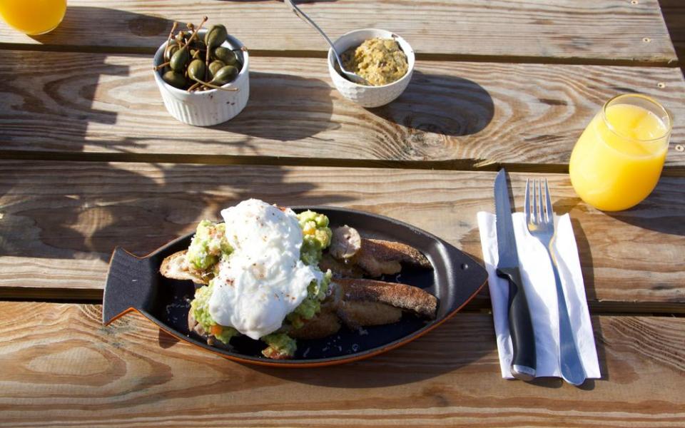 A breakfast of ingredients sourced on the property, including poached eggs on avocado toast. | Hernan F. Rodriguez