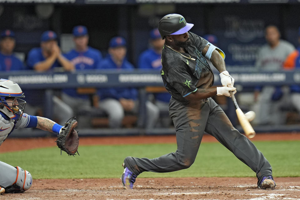 Tampa Bay Rays' Randy Arozarena connects for a solo home run off New York Mets relief pitcher Edwin Diaz during the ninth inning of a baseball game Sunday, May 5, 2024, in St. Petersburg, Fla. Catching for the Mets is Tomas Nido. (AP Photo/Chris O'Meara)