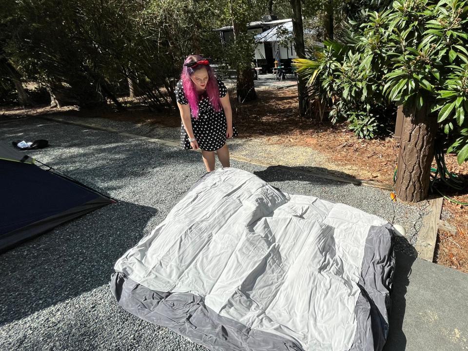 the writer inflating an air matress outside