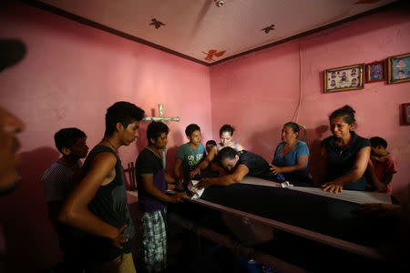 People mourn a police officer killed by the earthquake that struck off the southern coast of Mexico late on Thursday, in Juchitan, Mexico, September 9, 2017. REUTERS/Edgard Garrido