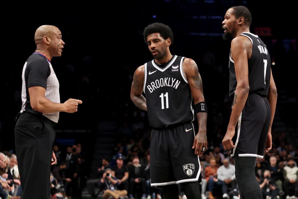 Mar 29, 2022; Brooklyn, New York, USA; Brooklyn Nets forward Kevin Durant (7) and guard Kyrie Irving (11) argue with referee Tre Maddox (23) during the second quarter at Barclays Center. Mandatory Credit: Brad Penner-USA TODAY Sports