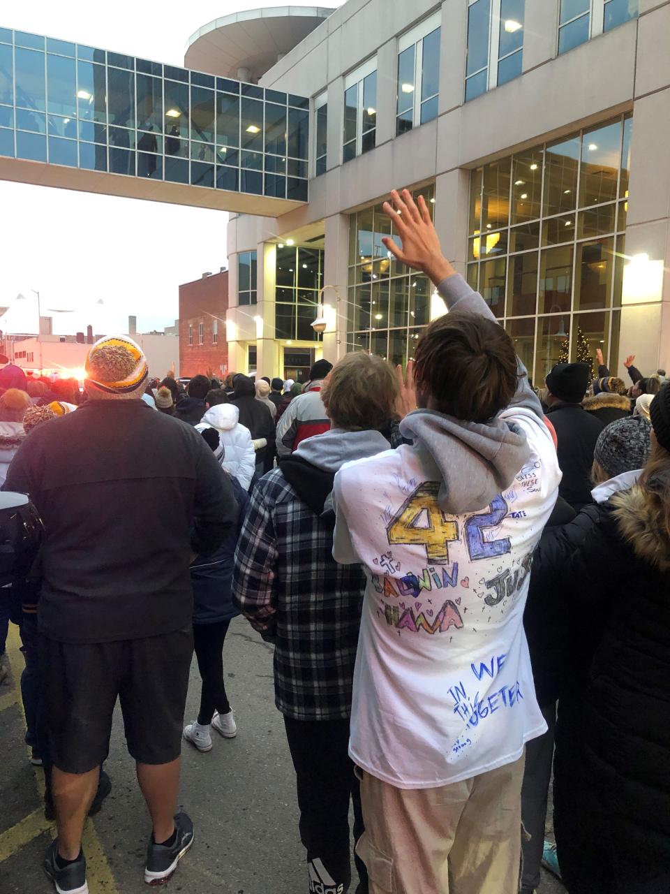 Jaden Sweeney, 17, a senior at Oxford High School made a shirt to honor his classmates killed Nov. 30, 2021, in a school shooting. He wears it to an honor walk in Pontiac on Dec. 3, 2021, for one of those students, Justin Shilling, 17.