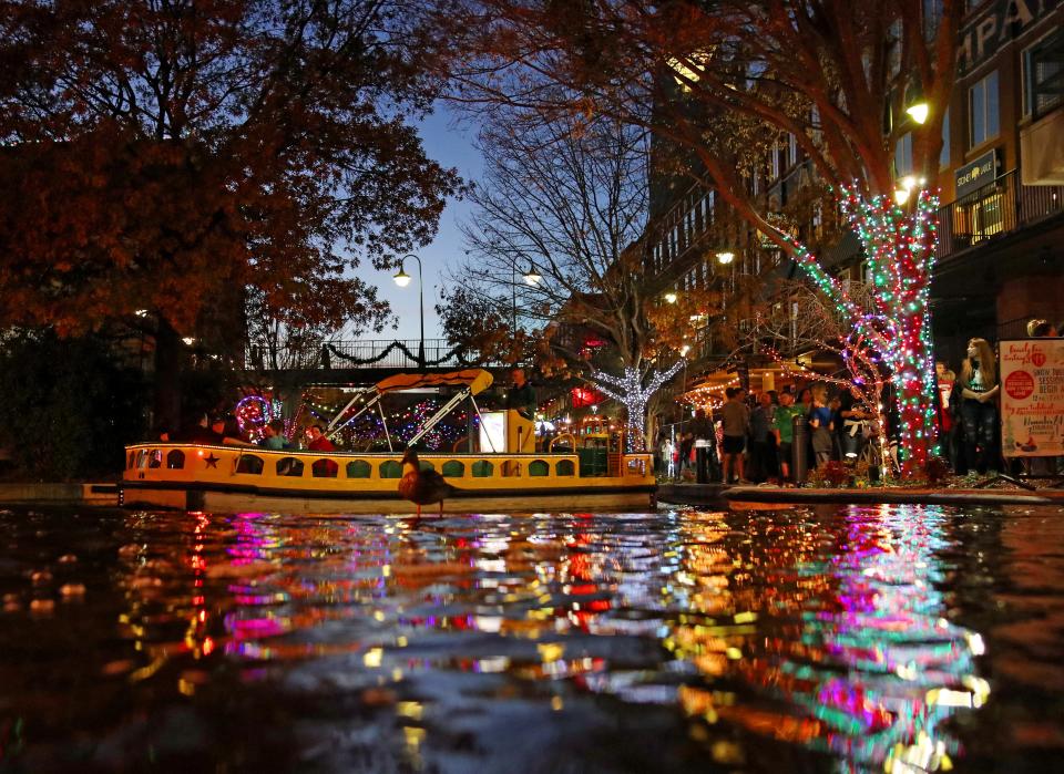 People take advantage of the first night for free Holiday Water Taxi rides to see the Bricktown Canal Lights on Friday, Nov. 24, 2017, as part of Downtown in December.