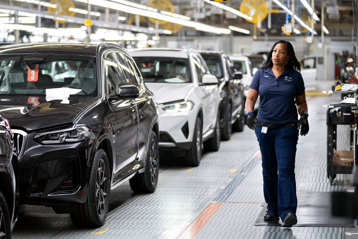 An employee works in the X3, X45 assembly hall at the BMW Spartanburg plant in Greer, S.C. Wednesday, Oct. 19, 2022. BMW’s sprawling factory near Spartanburg, will get a $1 billion investment, and the German automaker will spend another $700 million to build a battery plant nearby as it begins the transition to electric vehicles in the U.S., the company announced. (AP Photo/Sean Rayford)