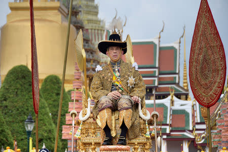 Thailand's King Maha Vajiralongkorn is transported on the royal palanquin by royal bearers during his visit to the Temple of the Emerald Buddha to proclaim himself the Royal Patron of Buddhism, inside the Grand Palace in Bangkok, Thailand, May 4, 2019. The Committee on Public Relations of the Coronation of King Rama X/Handout via REUTERS