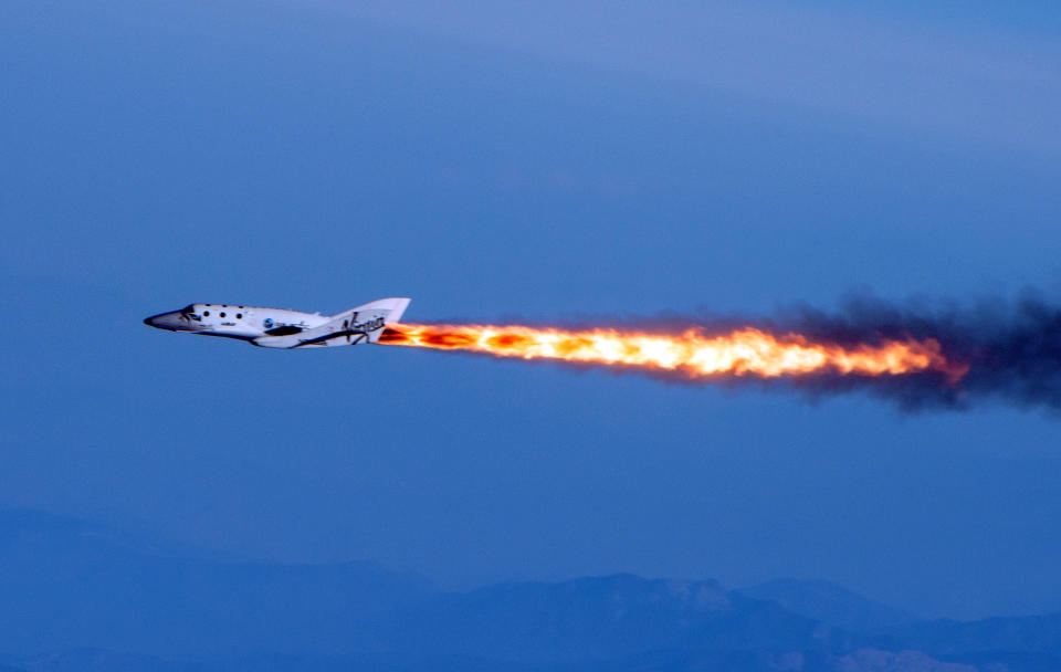 FILE - In this April 29, 2013 photo provided by Virgin Galactic, the company's SpaceShipTwo fires its rockets over Mojave, Calif. after it was dropped from its "mothership," WhiteKnightTwo. It is one of several new private ventures that involve taking people into outer space for a price, ventures that many hope will become as lucrative as they are revolutionary. And that prospect has California racing other states to woo new space companies with cushy incentives. (AP Photo/Virgin Galactic, Mark Greenberg, file)