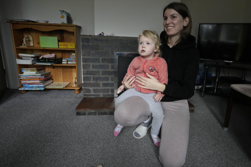 Viktoria Kovalenko and her daughter Varvara at their home in a village in Kent, Thursday, Feb. 9, 2023. Viktoria, 34, and her daughter Varvara are trying to settle in Britain after fleeing the war in Ukraine, where she lost her husband and 12-year-old daughter during a Russian military attack. The family have found housing through a charity, but they long to return to their own home in Ukraine. (AP Photo/Frank Augstein)