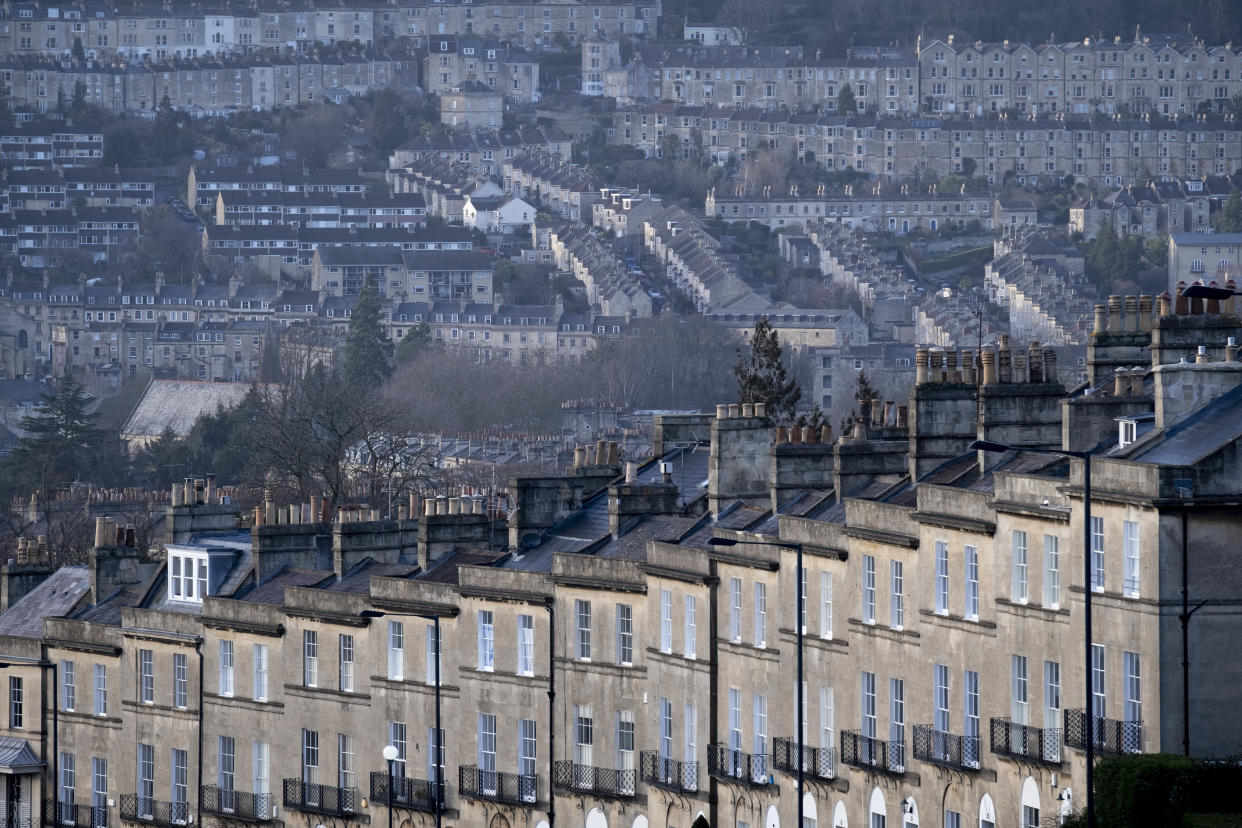 Seen from Bathwick Hill are foreground terraced homes at Dunsford Place on Bathwick Hill and in the distance, a cityscape of hillside properties around the city of Bath, on 19th February 2022, in Bath, England. The spa city of Bath was in the Roman period known as Aquae Sulis (