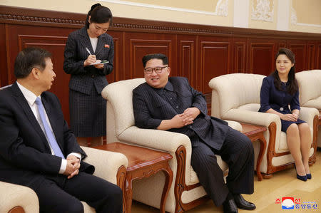 North Korean leader Kim Jong Un and his wife Ri Sol Ju meet with Song Tao, head of the International Department of Communist Party of China (CPC) Central Committee, in this undated photo released by North Korea's Korean Central News Agency (KCNA) in Pyongyang April 17, 2018. KCNA/via Reuters