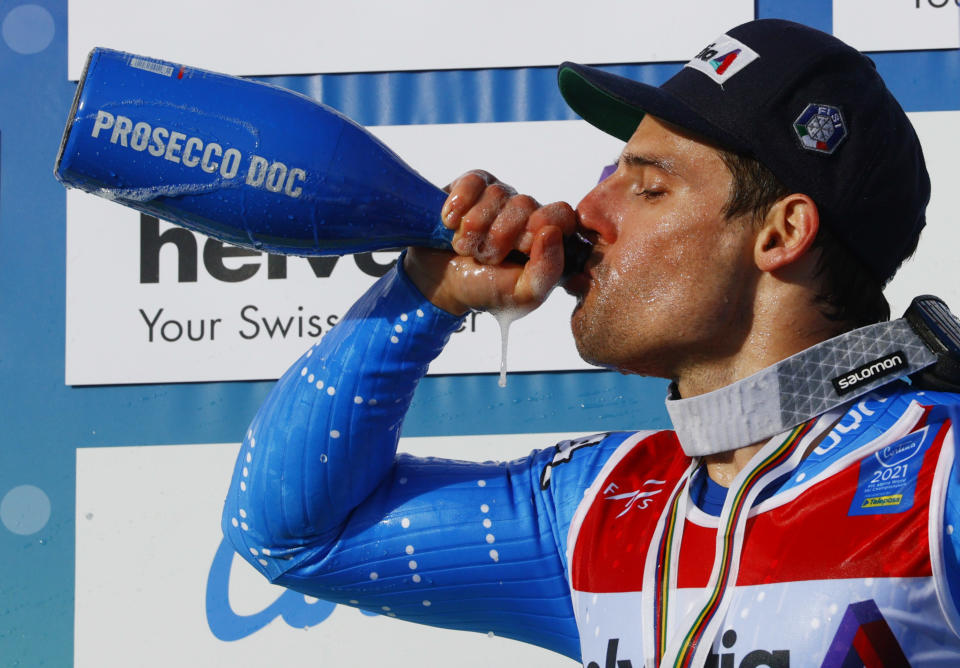 Alpine Skiing - FIS Alpine World Ski Championships - Cortina d'Ampezzo, Italy - February 19, 2021 Silver medalist Italy's Luca De Aliprandini drinks prosecco during the medal ceremony after the men's giant slalom REUTERS/Denis Balibouse