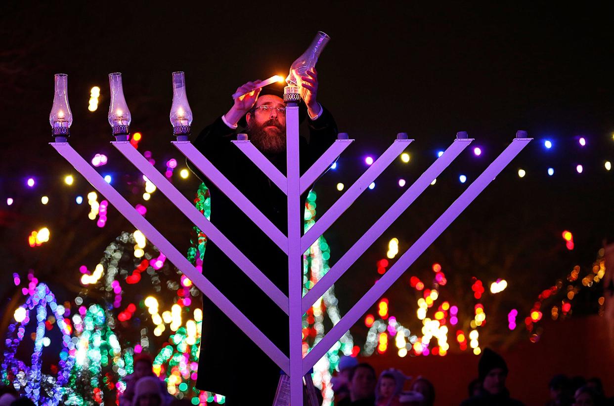 Rabbi Levi Andrusier lights a menorah at the Columbus Zoo and Aquarium on December 18, 2014. This event marked the first time the Jewish holiday was celebrated at the zoo, according to Becca Nitzberg , outreach director for the Jewish Community Center of Greater Columbus.